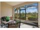 Covered patio with a grill, table, and seating area with lush green view at 2885 Attwater Loop, Winter Haven, FL 33884