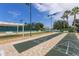 A community shuffleboard court area with multiple shuffleboard lanes, covered seating, and manicured landscaping at 2885 Attwater Loop, Winter Haven, FL 33884