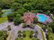 Aerial view of community clubhouse, pool, tennis courts, and parking at 2926 Siesta View Dr, Kissimmee, FL 34744