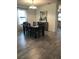 Dining room with dark wood table and chairs, light gray floors and neutral colored walls at 2926 Siesta View Dr, Kissimmee, FL 34744