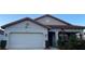 Charming single-story home featuring a two-car garage and well-maintained landscaping at 2926 Siesta View Dr, Kissimmee, FL 34744