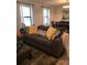 Bright living room features a comfy couch with throw pillows, lots of natural light, and an adjacent dining area at 2926 Siesta View Dr, Kissimmee, FL 34744