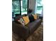 Comfortable living room with dark couch, large windows, and a view to the backyard at 2926 Siesta View Dr, Kissimmee, FL 34744