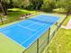 Bright blue community tennis court, fenced and well-maintained at 2926 Siesta View Dr, Kissimmee, FL 34744