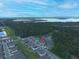 Community aerial view, showing neighborhood homes with a natural backdrop of lake and lush green trees at 297 Gina Ln, Davenport, FL 33837