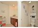 Well-lit bathroom with double sinks, wood cabinetry, and a separate toilet room for added privacy at 297 Gina Ln, Davenport, FL 33837