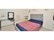 Inviting bedroom with a comfortable bed, stylish decor, and well-lit vanity area at 297 Gina Ln, Davenport, FL 33837
