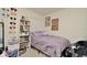 Cozy bedroom with a comfortable bed, window, decorated shelf, and unique wall decorations at 297 Gina Ln, Davenport, FL 33837