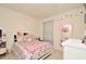 Charming bedroom with floral bedding, soft lighting, and playful decorations, creating a cozy atmosphere at 297 Gina Ln, Davenport, FL 33837