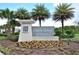 Beautiful entrance sign to Horse Creek at Crosswinds, surrounded by lush tropical landscaping and vibrant floral arrangements at 297 Gina Ln, Davenport, FL 33837