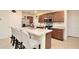 Well-appointed kitchen featuring a spacious island with seating, stainless steel appliances, and ample cabinet space at 297 Gina Ln, Davenport, FL 33837