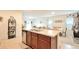 Open-concept kitchen featuring an island with a sink, seamless flow into the dining and living areas, and ample natural light at 297 Gina Ln, Davenport, FL 33837