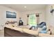 Relaxing living room featuring a large TV, comfortable seating, and sliding glass doors to a lush green outdoor space at 297 Gina Ln, Davenport, FL 33837