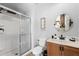 Modern bathroom features a glass enclosed shower, neutral paint, and updated vanity at 3055 Yellow Lantana Ln, Kissimmee, FL 34747