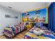 Themed ' bedroom with two twin beds, custom Paw Patrol mural, and colorful decor at 3055 Yellow Lantana Ln, Kissimmee, FL 34747