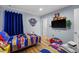 Themed ' bedroom features two twin beds, custom mural and tv at 3055 Yellow Lantana Ln, Kissimmee, FL 34747