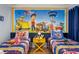 Brightly decorated themed bedroom with Paw Patrol mural, two twin beds and yellow nightstand at 3055 Yellow Lantana Ln, Kissimmee, FL 34747