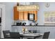 Dining room showcases modern chandelier, seating, and kitchen view at 3055 Yellow Lantana Ln, Kissimmee, FL 34747