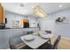 Charming dining area with modern chandelier and table setting for a cozy meal at 3055 Yellow Lantana Ln, Kissimmee, FL 34747