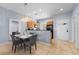 Inviting dining area with modern chandelier and view into the charming kitchen at 3055 Yellow Lantana Ln, Kissimmee, FL 34747