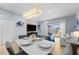 Bright dining area with modern chandelier, seating for six, and sliding glass doors to the patio at 3055 Yellow Lantana Ln, Kissimmee, FL 34747