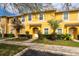 Charming yellow townhome with manicured landscaping, inviting entrance, and sunny curb appeal at 3055 Yellow Lantana Ln, Kissimmee, FL 34747