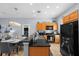 Open kitchen featuring black granite counters, stainless sink, and wooden cabinets at 3055 Yellow Lantana Ln, Kissimmee, FL 34747