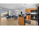 Open-concept kitchen with eat-in bar connected to the adjacent dining and living areas at 3055 Yellow Lantana Ln, Kissimmee, FL 34747