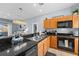 Kitchen boasts granite counters, wooden cabinets, and a cozy eat-in bar at 3055 Yellow Lantana Ln, Kissimmee, FL 34747