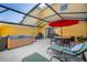 Back patio featuring a grill, table, hot tub and lounge chairs at 3055 Yellow Lantana Ln, Kissimmee, FL 34747