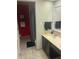 Well-lit bathroom with tile flooring, vanity, and a red accent wall adding a touch of character at 3100 Parkway Blvd # 325, Kissimmee, FL 34747