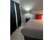 Charming bedroom with a comfortable bed, stylish floating nightstand, and elegant window drapes at 3100 Parkway Blvd # 325, Kissimmee, FL 34747
