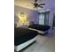 Cozy bedroom featuring two beds, stylish nightstands, and a modern ceiling fan for added comfort at 3100 Parkway Blvd # 325, Kissimmee, FL 34747