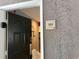 Condo entrance featuring a six-panel front door with a digital lock and unit number at 3100 Parkway Blvd # 325, Kissimmee, FL 34747