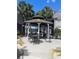 Outdoor gazebo with seating, offering a comfortable and shaded gathering spot amidst lush landscaping at 3100 Parkway Blvd # 325, Kissimmee, FL 34747