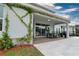 Exterior view of patio with lush greenery, dining area, and ambient string lights at 3262 Hanging Tide St, Winter Garden, FL 34787