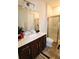 Well-lit bathroom features a sleek vanity with a modern sink, and a glass-enclosed shower for a spa-like experience at 3262 Hanging Tide St, Winter Garden, FL 34787