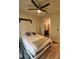 Neutral bedroom featuring a ceiling fan, a queen bed with a plush blanket, and an attached bathroom entrance at 3262 Hanging Tide St, Winter Garden, FL 34787