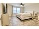 Bright bedroom featuring a large bed, ceiling fan, and neutral decor at 3262 Hanging Tide St, Winter Garden, FL 34787