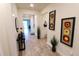Modern entryway with wood-look tile flooring, console table, mirror, and stylish wall art at 3262 Hanging Tide St, Winter Garden, FL 34787