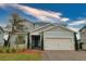 Charming two-story home showcasing a covered entry, attached two-car garage, and craftsman design details at 3262 Hanging Tide St, Winter Garden, FL 34787