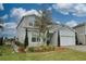 Charming two-story home showcasing landscaped front yard, attached two-car garage, and craftsman design details at 3262 Hanging Tide St, Winter Garden, FL 34787
