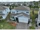Aerial front view of home with a two-car garage, landscaped yard, and charming curb appeal at 3262 Hanging Tide St, Winter Garden, FL 34787