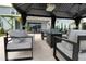 Gazebo with comfortable seating and gas fireplace overlooking outdoor kitchen and home at 3262 Hanging Tide St, Winter Garden, FL 34787
