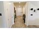 Inviting hallway with wood-look floors, crisp white walls, and modern lighting, creating a welcoming entrance at 3262 Hanging Tide St, Winter Garden, FL 34787