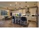 A modern kitchen with white cabinets, a center island with bar stool seating, and stainless steel appliances at 3262 Hanging Tide St, Winter Garden, FL 34787
