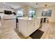 Stylish kitchen featuring a center island with bar seating, stainless steel appliances, and wood-look tile flooring at 3262 Hanging Tide St, Winter Garden, FL 34787