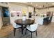 Open-concept kitchen with white cabinets, stainless steel appliances, and center island, adjacent to the dining area at 3262 Hanging Tide St, Winter Garden, FL 34787