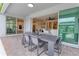 Covered patio with a dining table and views into the living room and kitchen at 3262 Hanging Tide St, Winter Garden, FL 34787