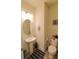 Well-lit half bathroom features a pedestal sink, toilet, and decorative accents for a stylish and functional space at 3262 Hanging Tide St, Winter Garden, FL 34787